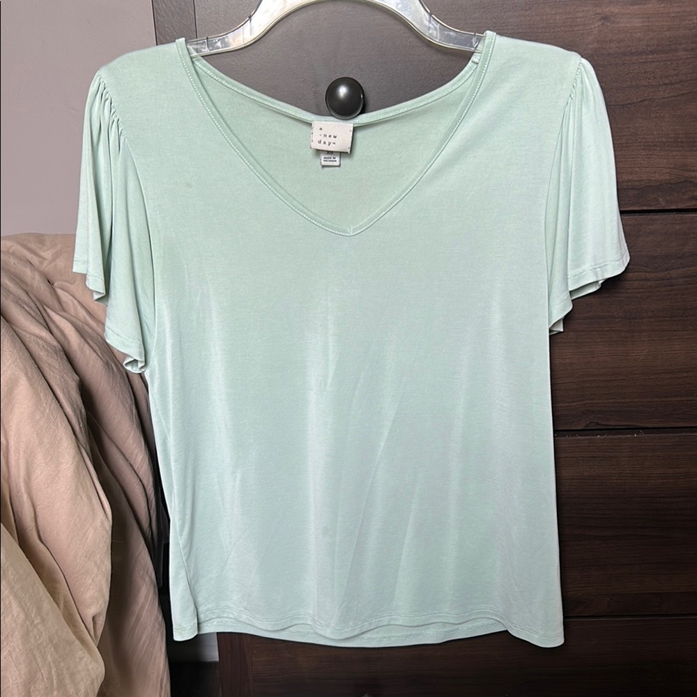 A New Day - Mint Green V-Neck Women's Top. Two spots shown on pictures